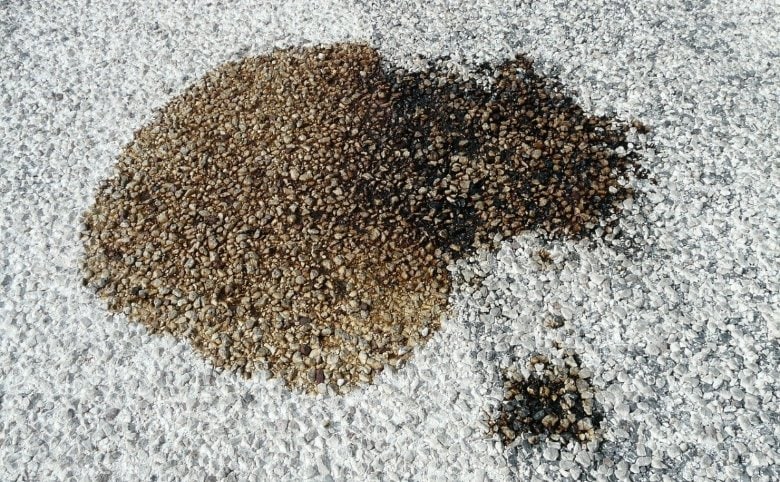 An oil stain on the asphalt floor
